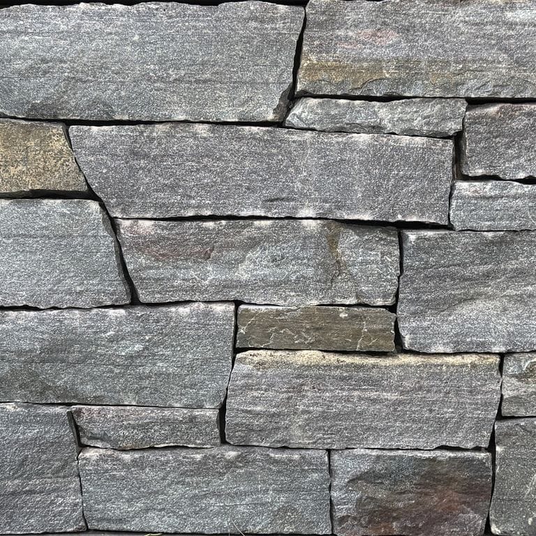 Color/Finish variation image for Lake Korynth Granite. The surface finish shown is split-face. The dominant color shown is gray. The color mix creates a warm feeling.