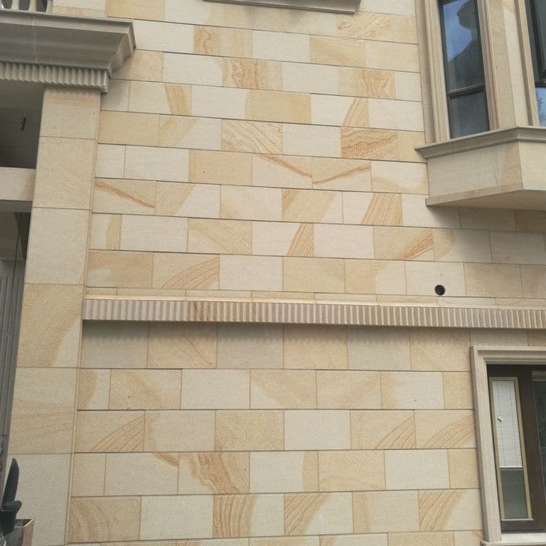 Application image for Beige Vein Cut Granite. The image shows this material being used for full bed veneer and thin veneer. Dominant colors shown are orange/rust and tan. The color mix creates a warm feeling.