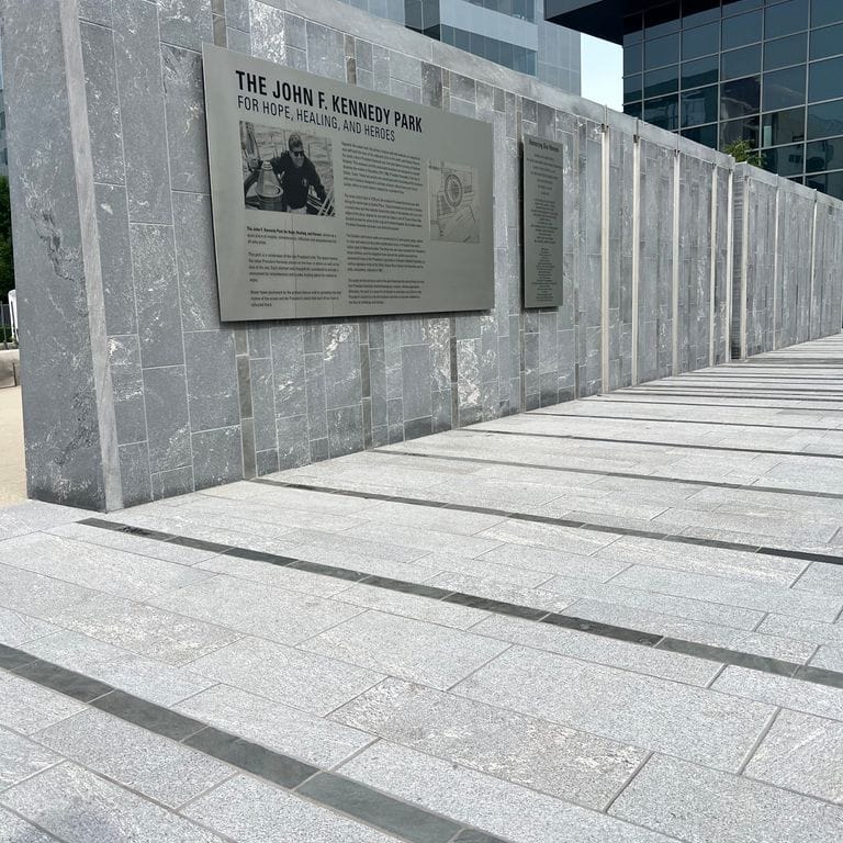 Application image for Strata Mist Cross-Cut Gneiss. The image shows this material being used for patio pavers, full bed veneer, thin veneer and public area. The dominant color shown is gray. The color mix creates a cool feeling.