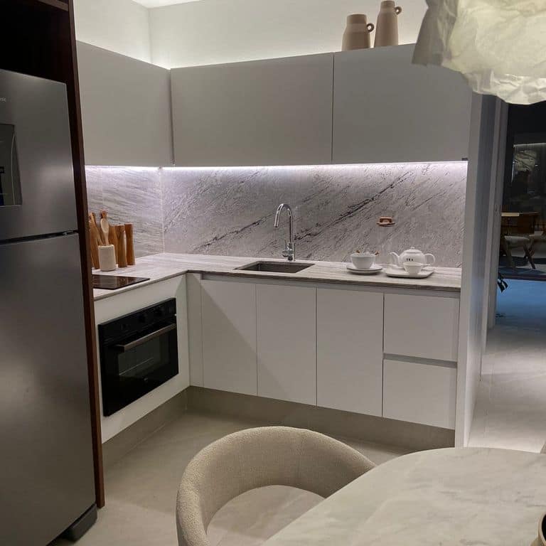 Application image for Strata Snow Gneiss. The image shows this material being used for countertop slabs and interior cladding. The surface finish shown is polished. Dominant colors shown are gray and white. The color mix creates a cool feeling.