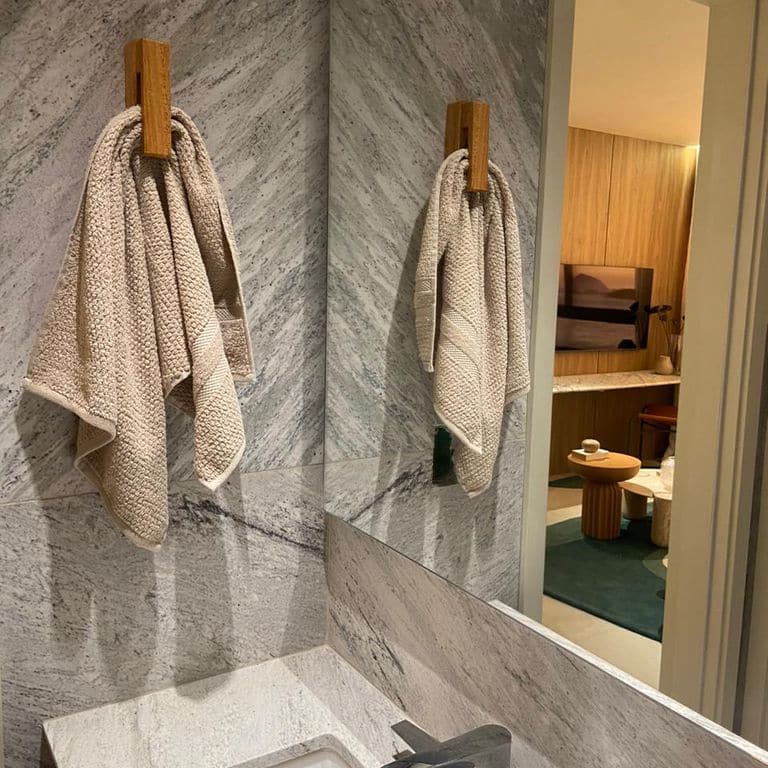 Application image for Strata Snow Gneiss. The image shows this material being used in an interior cladding application. The surface finish shown is polished. Dominant colors shown are gray and white. The color mix creates a cool feeling.