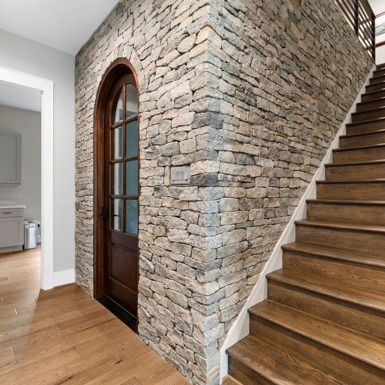Feature image for Boston Blend Granite. The image shows this material being used in a thin veneer application. The surface finish shown is split-face. Dominant colors shown are beige, gray and tan. The color mix creates a warm feeling.