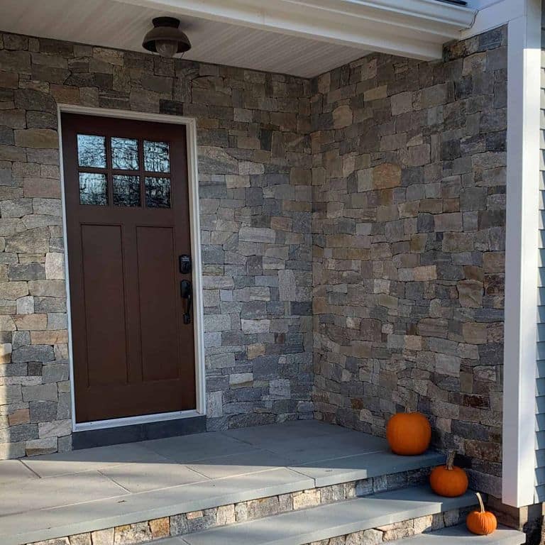 Application image for Boston Blend Granite. The image shows this material being used in a thin veneer application. The surface finish shown is split-face. Dominant colors shown are brown, gray and tan. The color mix creates a warm feeling.