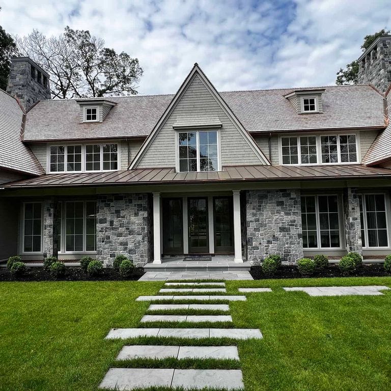 Feature image for Oyster Bay Granite. The image shows this material being used in a thin veneer application. The surface finish shown is . The dominant color shown is gray.