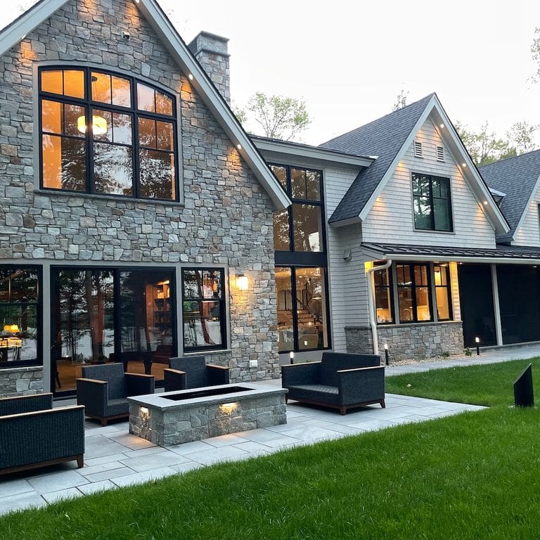 Application image for Newport Mist Granite. The image shows this material being used in a full bed veneer application. The surface finish shown is split-face. Dominant colors shown are gray and tan. The color mix creates a warm feeling.