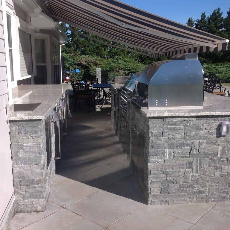 Application image for Greenwich Gray Granite. The image shows this material being used in a thin veneer application. The surface finish shown is split-face. The dominant color shown is gray. The color mix creates a cool feeling.