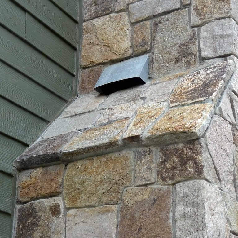 Best close-up image for New England Tan Granite. The image shows this material being used in a thin veneer application. The surface finish shown is . Dominant colors shown are gray and tan. The color mix creates a warm feeling.