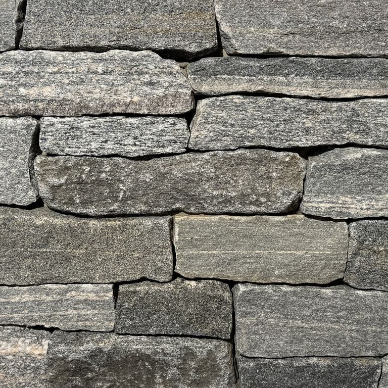 Color/Finish variation image for Mystic Harbor Granite. The surface finish shown is split-face. The dominant color shown is gray. The color mix creates a warm feeling.