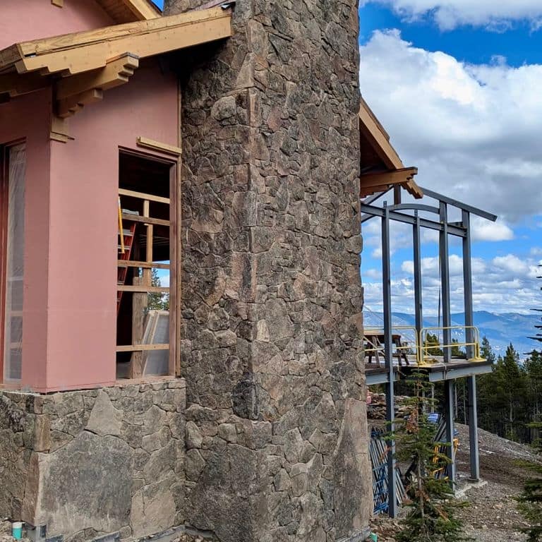 Application image for Montana Moss Rock. The image shows this material being used in a thin veneer application. Dominant colors shown are brown and gray. The color mix creates a cool feeling.