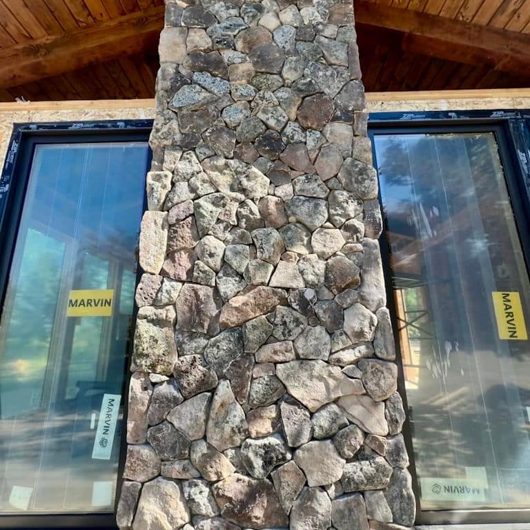 Application image for Montana Moss Rock. The image shows this material being used in a full bed veneer application. Dominant colors shown are brown and gray.