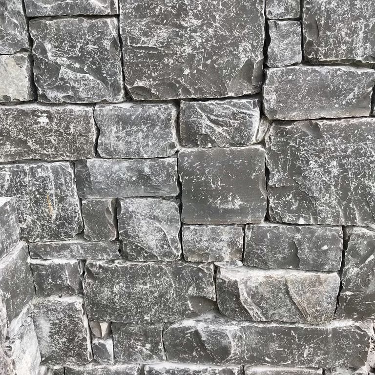 Application image for Mountain Storm Limestone. The image shows this material being used for full bed veneer and thin veneer. The dominant color shown is gray. The color mix creates a cool feeling.