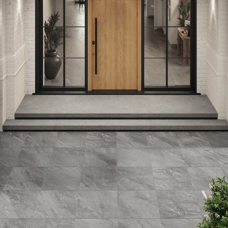 Feature image for Legacy Marblestone Steel. The image shows this material being used in a patio pavers application. The dominant color shown is gray. The color mix creates a cool feeling.