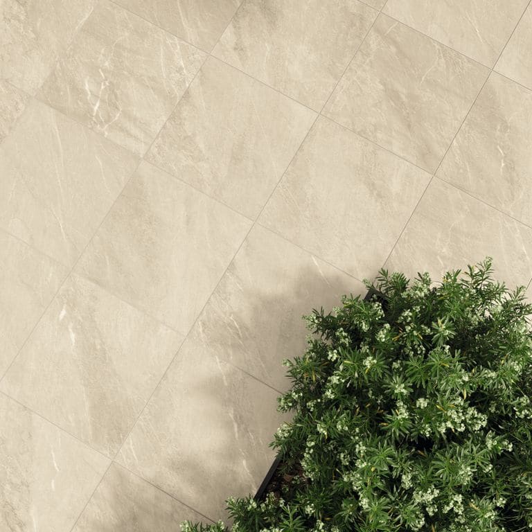 Feature image for Legacy Marblestone Sand. The image shows this material being used in a patio pavers application. The surface finish shown is . Dominant colors shown are beige and cream. The color mix creates a warm feeling.