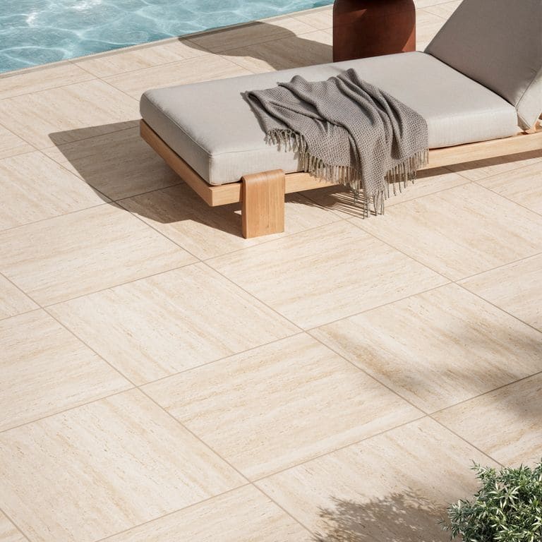 Feature image for Travertino Ivory. The image shows this material being used for patio pavers and pool deck pavers. The surface finish shown is . Dominant colors shown are beige and cream. The color mix creates a warm feeling.