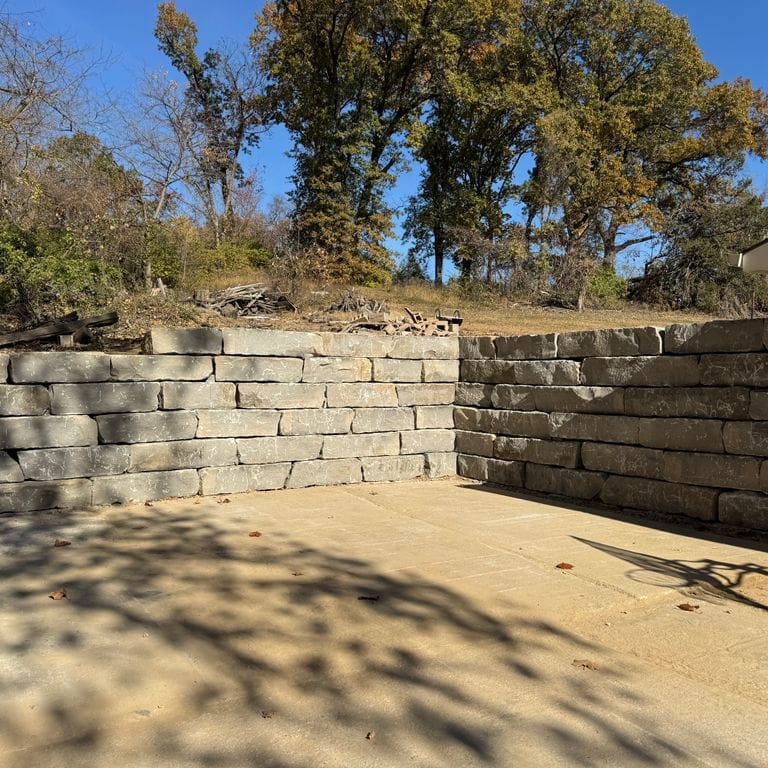 Application image for Great Plains Limestone - Gray. The image shows this material being used for landscape wallstone and retaining wall. The surface finish shown is split-face. Dominant colors shown are gray and tan. The color mix creates a warm feeling.