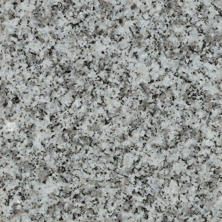 Feature image for Woodbury Granite. The surface finish shown is flamed. Dominant colors shown are gray and white; with beige, black and cream secondaries. The color mix creates a cool feeling. Speckled and coarse speckled color patterns. Contains some mica.