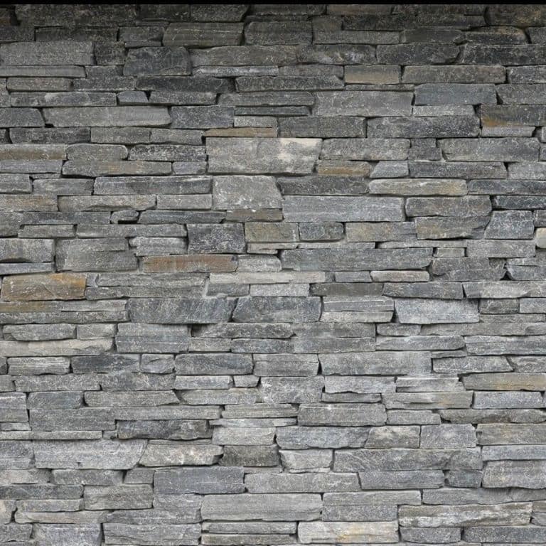 Best close-up image for Charcoal Oakley Stone. The image shows this material being used for full bed veneer and thin veneer. The surface finish shown is split-face. The dominant color shown is gray. The color mix creates a cool feeling.