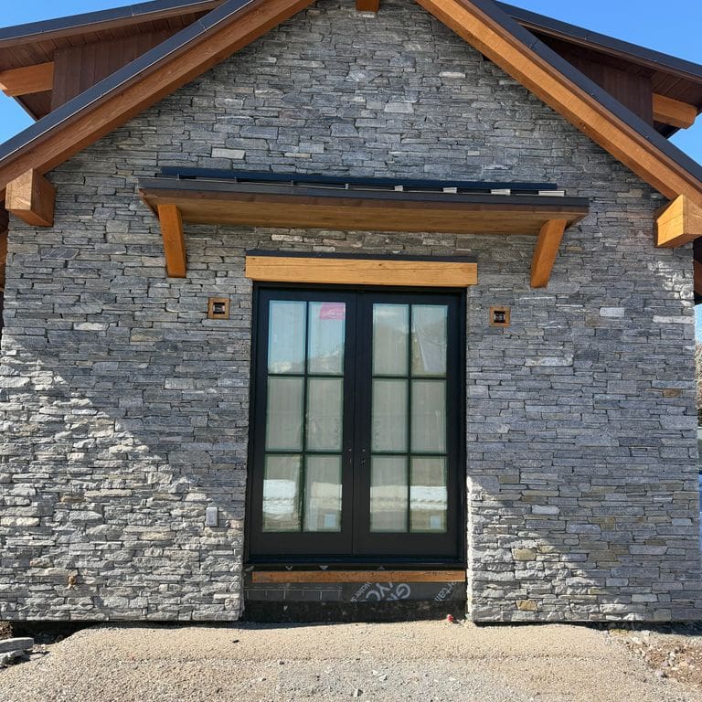 Application image for Charcoal Oakley Stone. The image shows this material being used in a full bed veneer application. The surface finish shown is split-face. The dominant color shown is gray. The color mix creates a cool feeling.