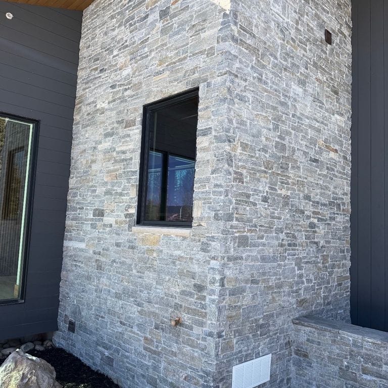 Application image for Charcoal Oakley Stone. The image shows this material being used in a full bed veneer application. The dominant color shown is gray. The color mix creates a cool feeling.