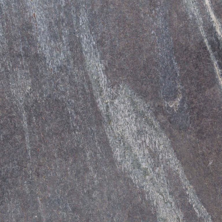 Color/Finish variation image for Granite - Mystic Mountain- Flamed. The dominant color shown is gray; with blue, brown, green and purple secondaries. Exhibits "movement" and the color mix creates a cool feeling. Streaked and marbled color patterns.