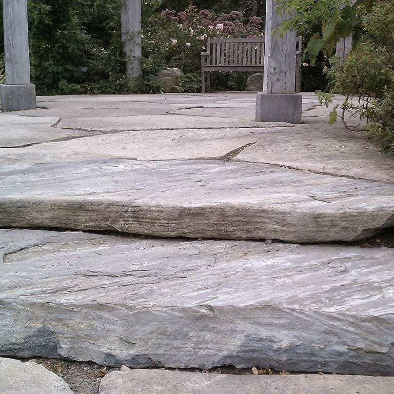 Application image for Mystic Mountain - Natural. The image shows this material being used for patio pavers, landings and monolithic steps. The dominant color shown is gray. Exhibits "movement" and the color mix creates a warm feeling. Streaked color pattern.