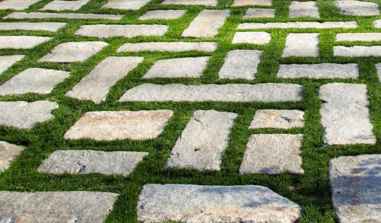 Application image for Reclaimed New England Granite Cobblestones - Super Jumbo. The image shows this material being used in a patio pavers application. The surface finish shown is . Dominant colors shown are beige and gray. The color mix creates a warm feeling.