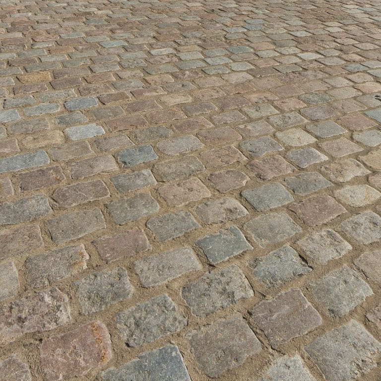 Application image for Reclaimed Swedish Granite Cobblestones. The image shows this material being used in a driveway pavers application. The surface finish shown is . Dominant colors shown are brown, gray and tan. The color mix creates a warm feeling.