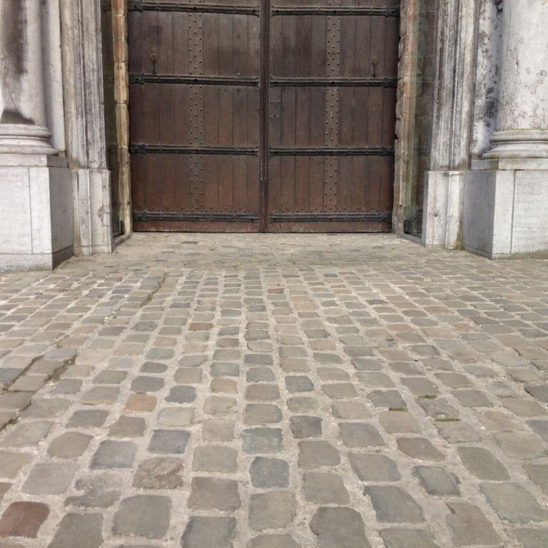 Application image for Sandstone - Reclaimed European Cobblestones. The image shows this material being used in a patio pavers application. The surface finish shown is sawn. Dominant colors shown are brown and gray. The color mix creates a warm feeling.
