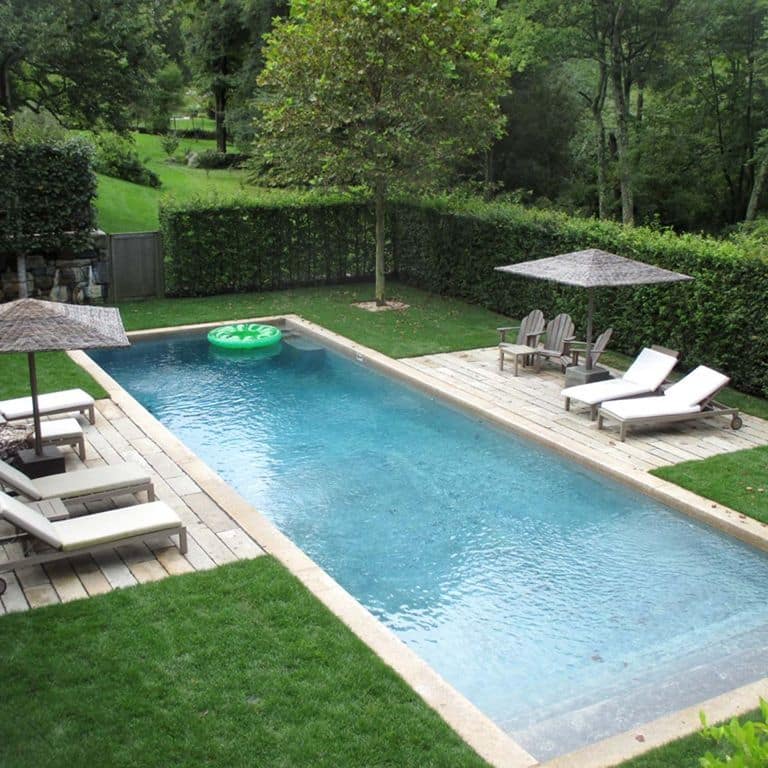 Application image for Reclaimed Footworn Granite Planks. The image shows this material being used for pool coping, patio pavers and pool deck pavers. The dominant color shown is gray.