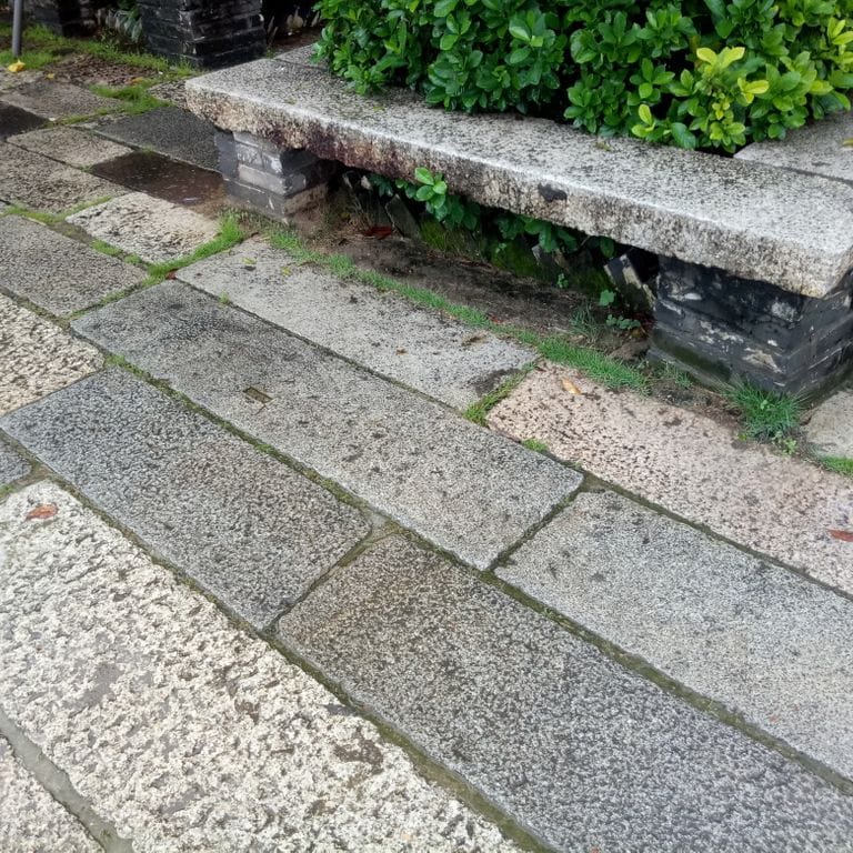 Application image for Reclaimed Footworn Granite Planks. The image shows this material being used for seating &amp; benches and patio pavers. The dominant color shown is gray. The color mix creates a warm feeling.