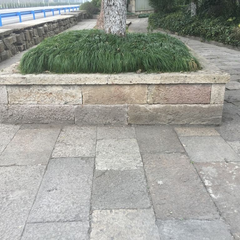 The image shows this material being used in a path pavers application.