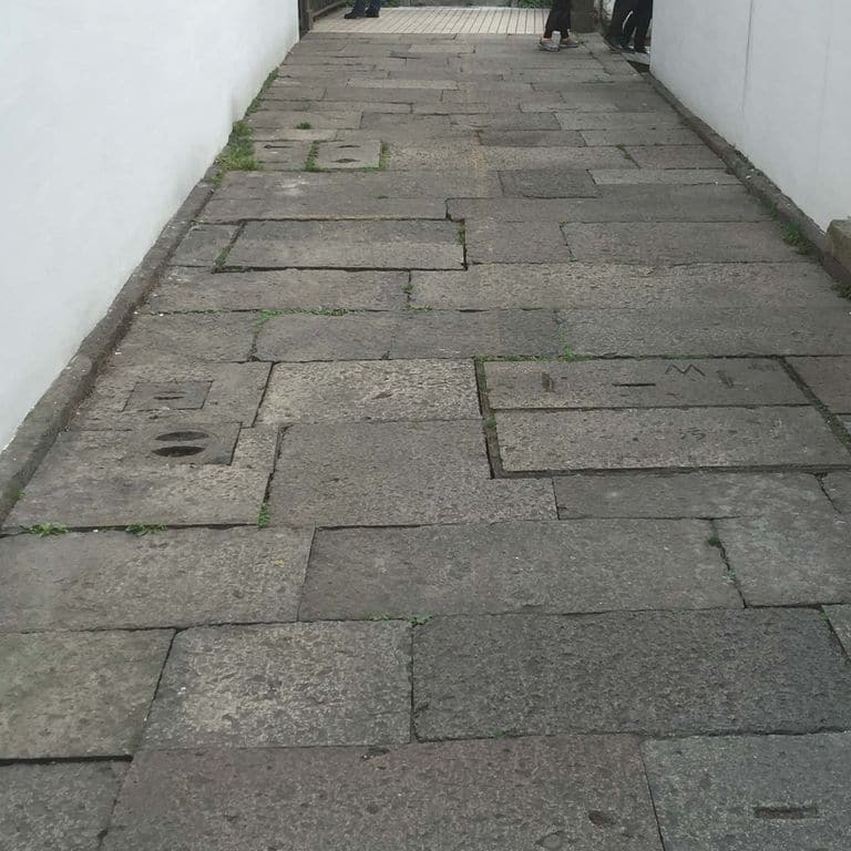 The image shows this material being used in a path pavers application.