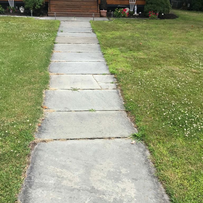 The image shows this material being used in a path pavers application.