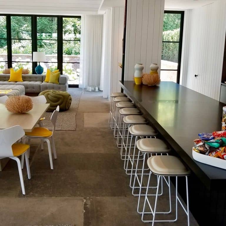 Feature image for Reclaimed Sandstone Sidewalk Stones. The image shows this material being used in an interior floor application. Dominant colors shown are brown and gray; with beige, orange/rust and tan secondaries. The color mix creates a warm feeling. Regular color pattern.