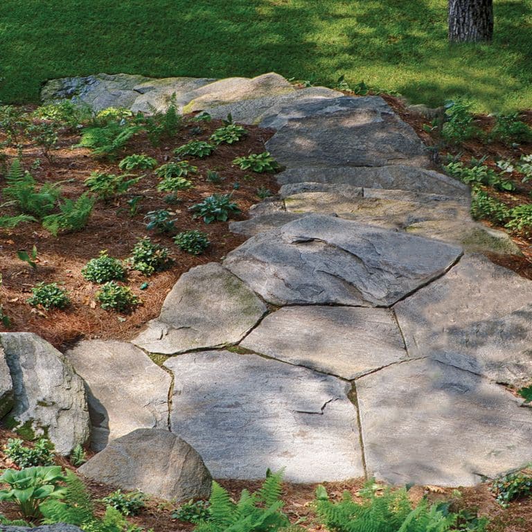 The image shows this material being used for path pavers and monolithic steps. Dominant colors shown are brown and gray; with beige, purple and tan secondaries. Regular color pattern.