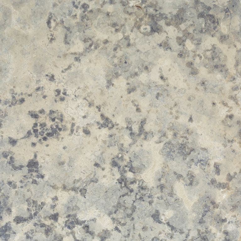 Color/Finish variation image for Mountain Hard Limestone - Blue. The surface finish shown is polished. Dominant colors shown are beige and gray; with white, tan and cream secondaries. Exhibits "movement". Blotched color pattern.