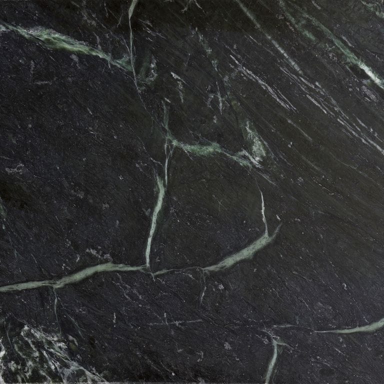 Best close-up image for Vermont Verde Soapstone. The surface finish shown is antiqued. Dominant colors shown are black and green; with green, gray and white secondaries. Exhibits "movement" and the color mix creates a cool feeling. Streaked, marbled, veined and swirled color patterns.