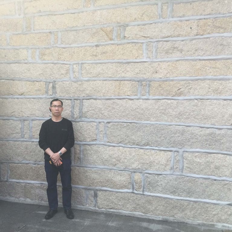 Application image for Reclaimed Granite Plank Veneer. The image shows this material being used in a full bed veneer application. The surface finish shown is . Dominant colors shown are beige and gray. The color mix creates a warm feeling. Regular color pattern.