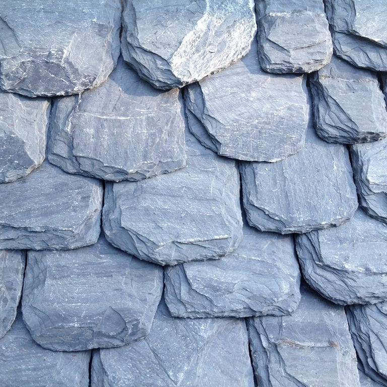 Application image for Slate - Vermont Slate - Striated Gray. The image shows this material being used in a Roof Shingles application. This is a landscape stone for indoor and outdoor commercial and residential applications. Suitable for general use, freeze-thaw conditions and high traffic areas situations. Moderate to higher on the price spectrum.