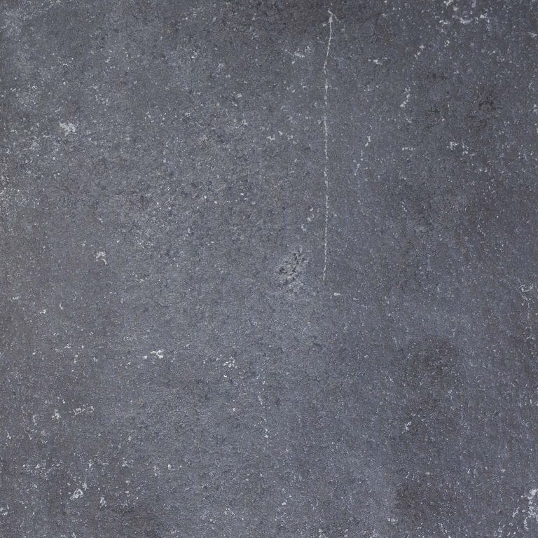 Color/Finish variation image for Bahama Black Limestone. The surface finish shown is flamed. The dominant color shown is gray; with blue and purple secondaries. The color mix creates a cool feeling. Solid and cloudy color patterns.