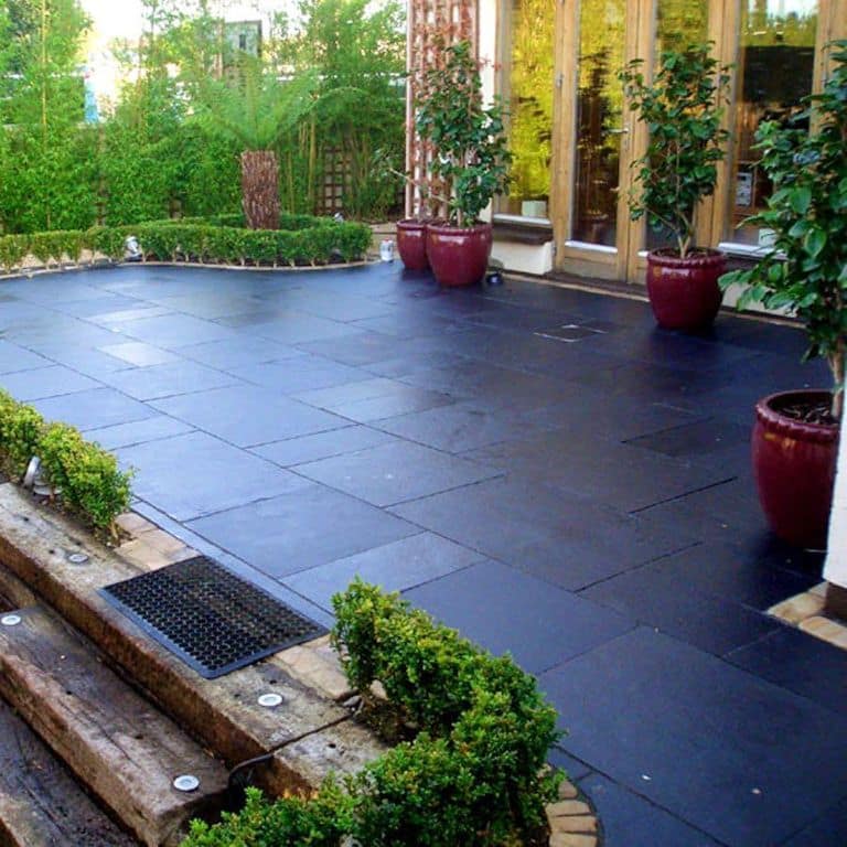 The image shows this material being used in a patio pavers application.