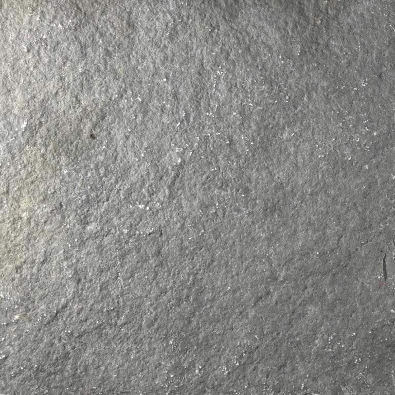 Color/Finish variation image for Mississippi Grey Limestone. The surface finishes shown are brushed and split-face with flat plane. The dominant color shown is gray; with beige and green secondaries. The color mix creates a cool feeling. Regular, fine speckled and cloudy color patterns.