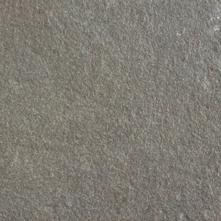Close-up image for Mississippi Grey Limestone. The surface finishes shown are brushed and flamed. Dominant colors shown are green, gray and tan; with brown and purple secondaries. Solid and fine speckled color patterns.