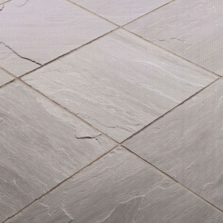 Best close-up image for Sandstone - Asheville. The image shows this material being used in a path pavers application. The dominant color shown is gray; with beige, pink, purple, white and tan secondaries. Exhibits "movement". Regular and linear color patterns.
