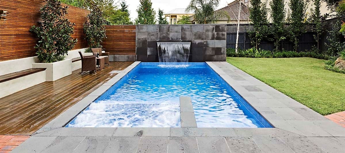 The image shows this material being used in a pool deck pavers application.