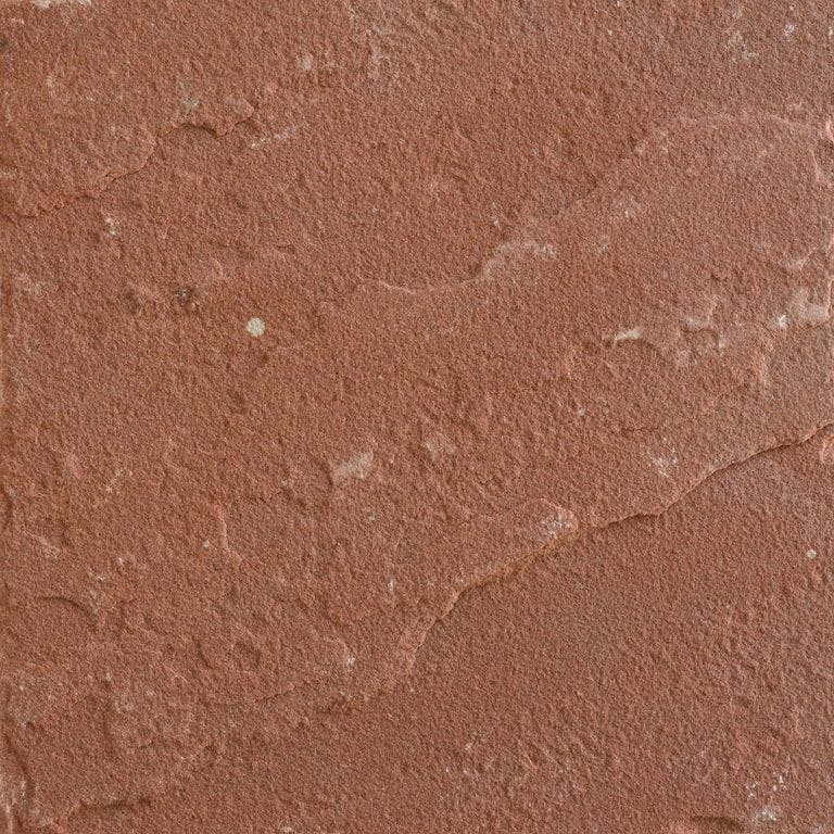Feature image for Terra Sandstone. The surface finish shown is natural cleft. Dominant colors shown are orange/rust and red; with a tan secondary. The color mix creates a warm feeling. Solid color pattern.