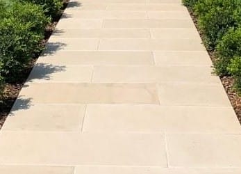 Close-up image for Portland White Sandstone. The surface finish shown is flamed. Dominant colors shown are beige, tan and cream. The color mix creates a warm feeling. Solid color pattern.