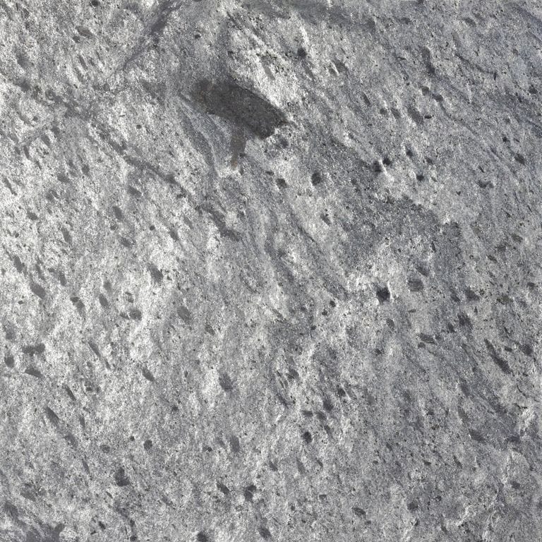 Color/Finish variation image for Amazon Quartzite. The surface finish shown is honed. The dominant color shown is gray; with green and white secondaries. Exhibits "movement" and the color mix creates a cool feeling. Random, coarse speckled, blotched and cloudy color patterns. Contains some mica and mineral inclusions.