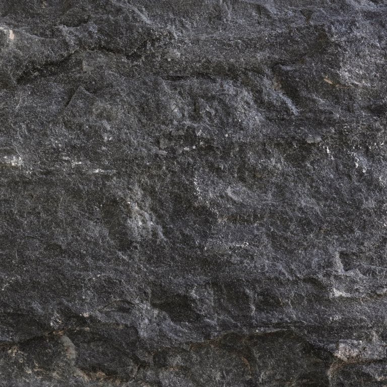 Feature image for Titanium Quartzite. Dominant colors shown are black, brown and gray. The color mix creates a cool feeling. Regular color pattern.
