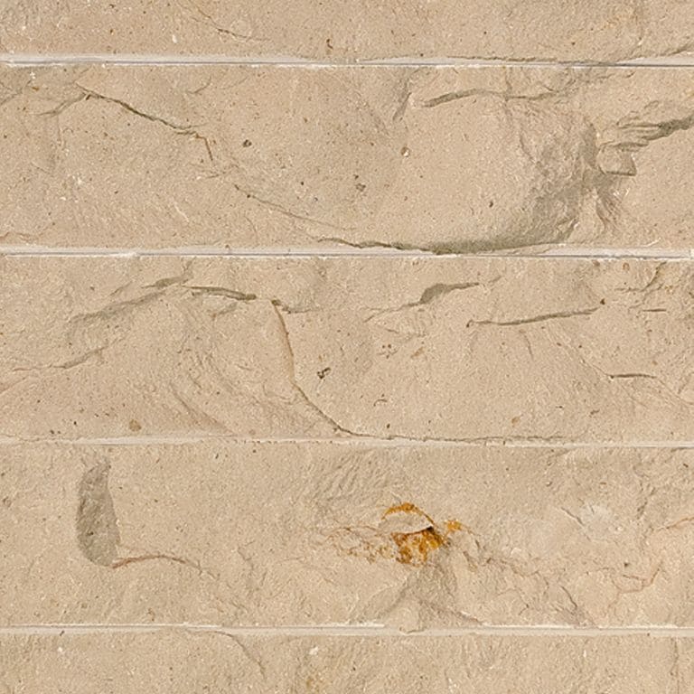 Color/Finish variation image for Cream Limestone. The surface finish shown is chiseled. Dominant colors shown are beige and tan; with brown, orange/rust and cream secondaries. Exhibits "movement" and the color mix creates a warm feeling. Regular, linear and cloudy color patterns.